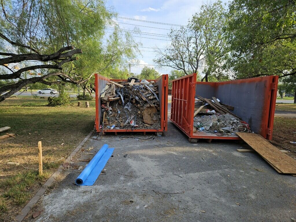 Roll-off dumpsters loaded with construction debris on a Rio Grande Valley job site